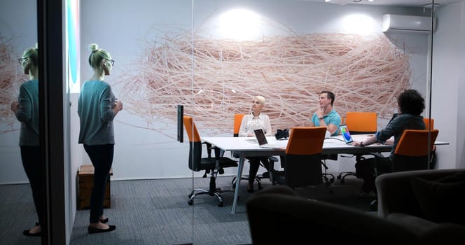 Group of a young business people discussing business plan at modern startup office building