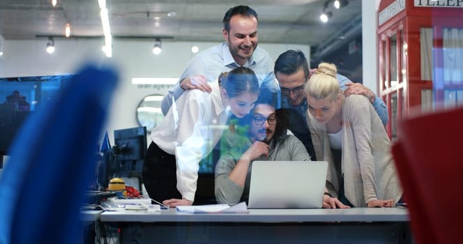 Group of a young business people discussing business plan at modern startup office building