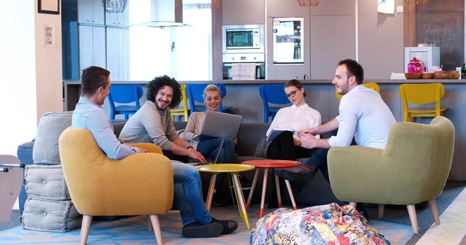 Group of a young business people discussing business plan at modern startup office building