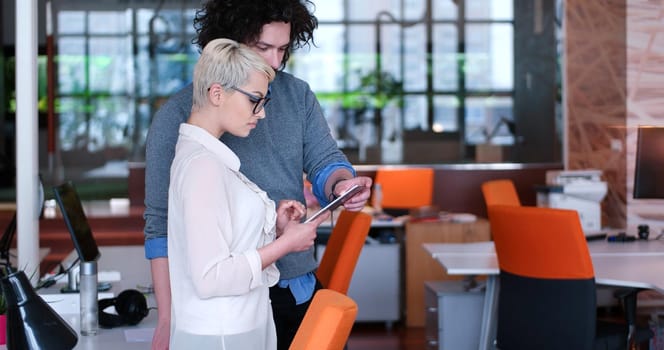 two business people using tablet  preparing for next meeting and discussing ideas