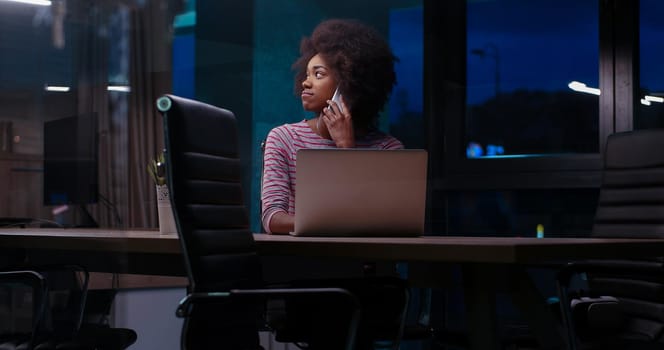 Young african american female Entrepreneur Freelancer Working Using A Laptop In night Coworking space