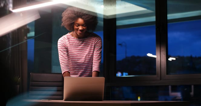 Young african american female Entrepreneur Freelancer Working Using A Laptop In night Coworking space