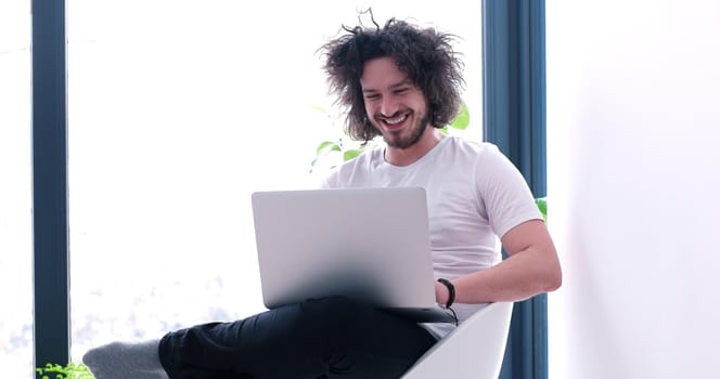 Real man Using laptop At Home Drinking Coffee Enjoying Relaxing