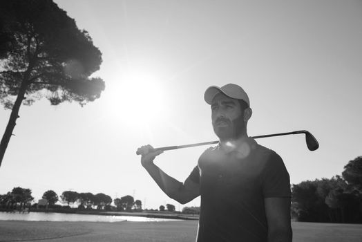 handsome middle eastern golf player portrait at course on beautiful sunset in backgeound