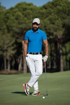 handsome middle eastern golf player portrait at course at sunny day