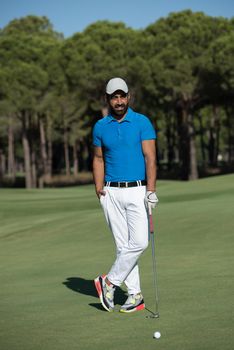 handsome middle eastern golf player portrait at course at sunny day