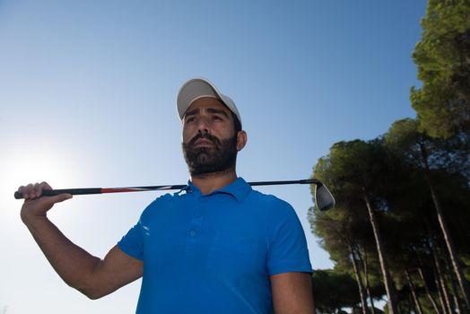 handsome middle eastern golf player portrait at course on beautiful sunset in backgeound