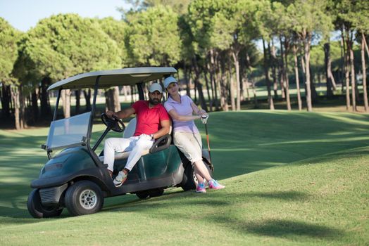 couple in buggy cart on golf course