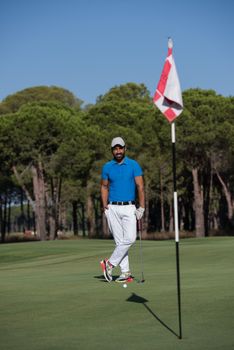 handsome middle eastern golf player portrait at course at sunny day