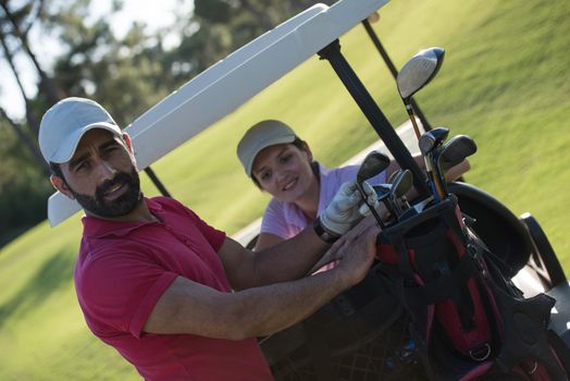 couple in buggy cart on golf course