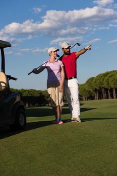 portrait of happy young  golfers couple on golf course