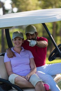 couple in buggy cart on golf course