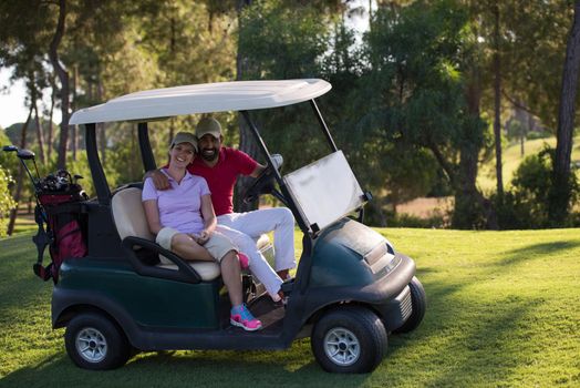 couple in buggy cart on golf course