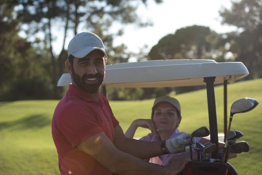 couple in buggy cart on golf course