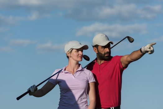 portrait of happy young  couple on golf course
