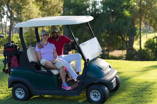 couple in buggy cart on golf course