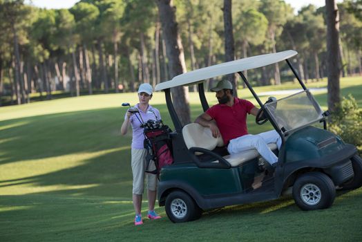 couple in buggy cart on golf course