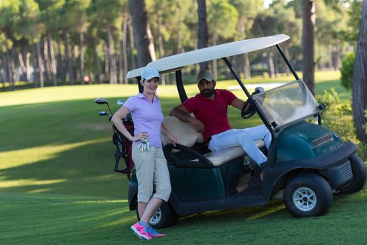 couple in buggy cart on golf course