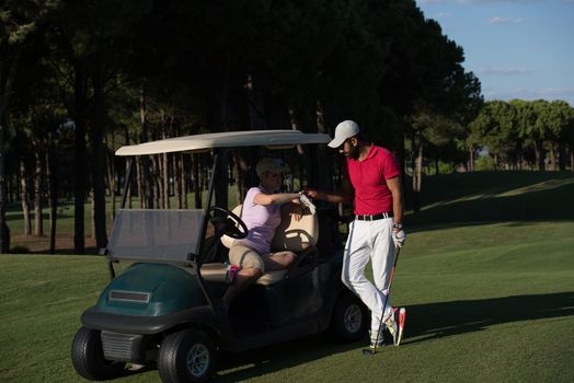 couple in buggy cart on golf course