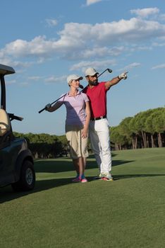 portrait of happy young  golfers couple on golf course