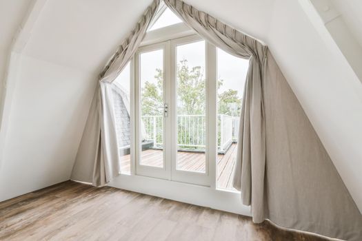 Large doors of unusual shape leading to the balcony