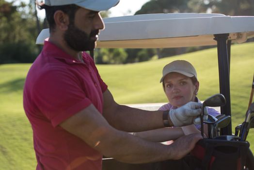 couple in buggy cart on golf course