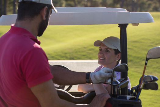 couple in buggy cart on golf course