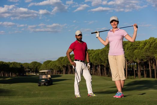 portrait of happy young  couple on golf course