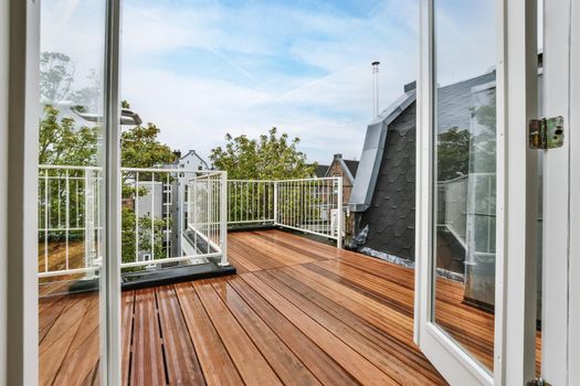 Rooftop exterior with delightful wood flooring and white railings
