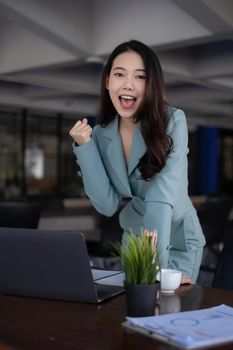 Excited asian business woman and celebrating success and video call with her business team. Finance, tax, fund, account concept