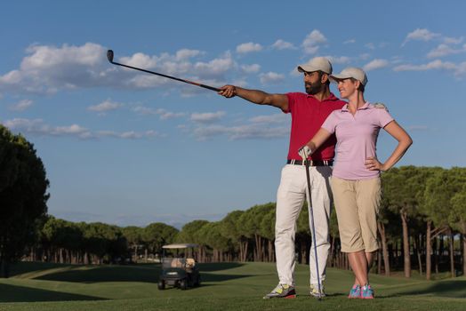 portrait of happy young  couple on golf course