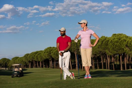 portrait of happy young  couple on golf course