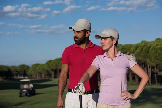 portrait of happy young  couple on golf course