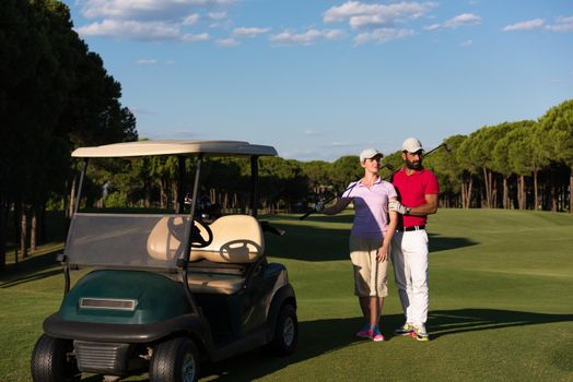 couple in buggy cart on golf course