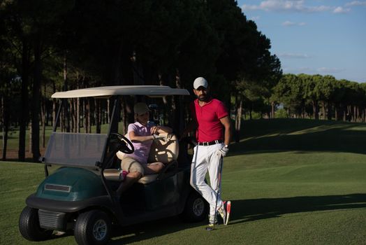 couple in buggy cart on golf course