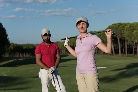 portrait of happy young  couple on golf course