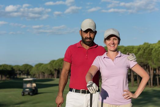 portrait of happy young  couple on golf course