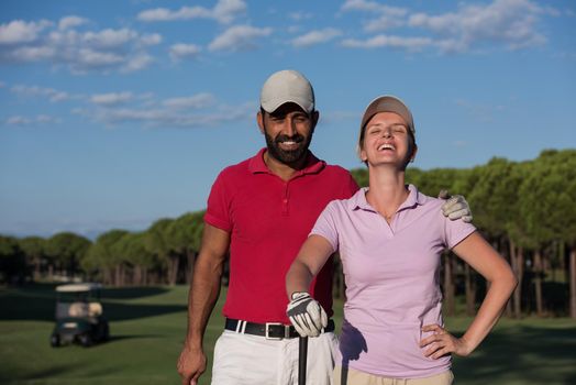 portrait of happy young  couple on golf course