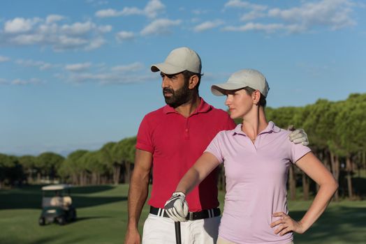 portrait of happy young  couple on golf course