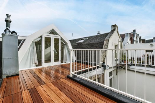 Rooftop exterior with delightful wood flooring and white railings