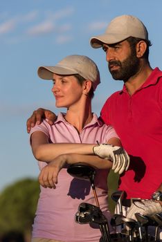 portrait of happy young  couple on golf course