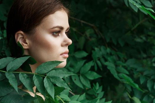 portrait of a woman green leaves clean skin nature summer Lifestyle. High quality photo