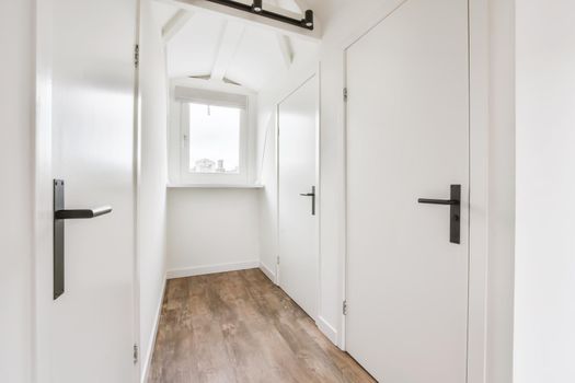 Stunning hallway with dark parquet floors and white walls