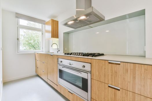 Long kitchen area with wooden kitchen unit