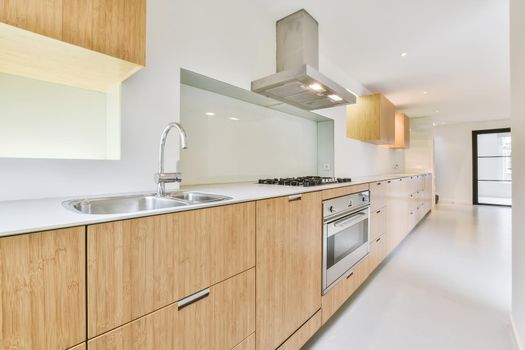 Long kitchen area with wooden kitchen unit