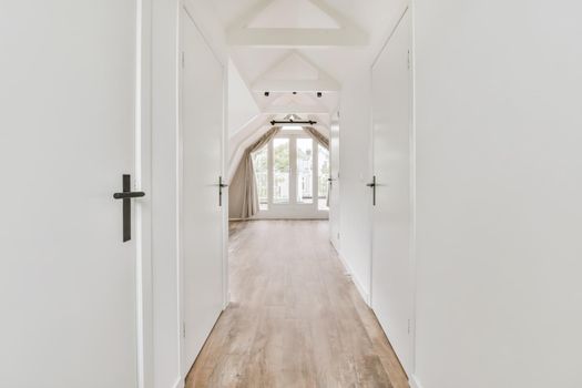 Stunning hallway with dark parquet floors and white walls