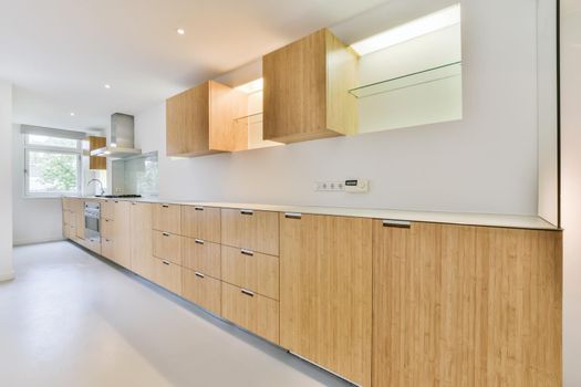 Long kitchen area with wooden kitchen unit