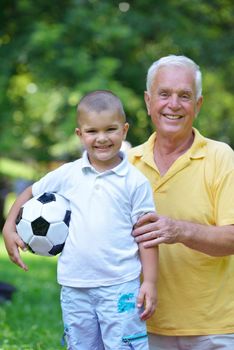 happy grandfather and child have fun and play in park