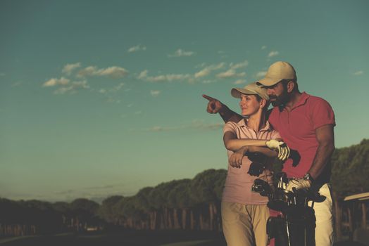 portrait of happy young  couple on golf course