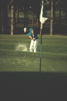 pro golf player shot ball from sand bunker at course